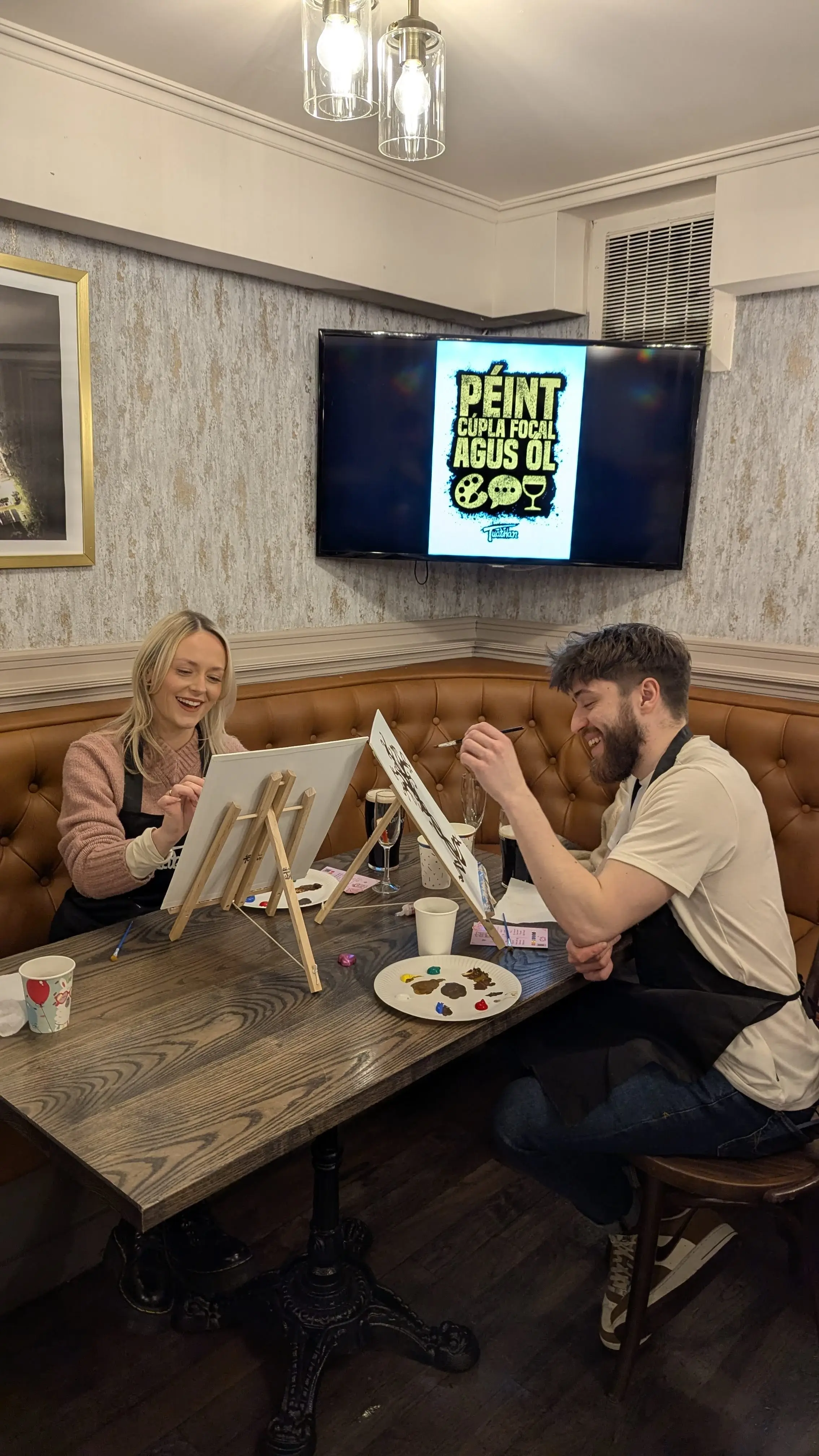 Attendees painting at a Péint agus Ól event