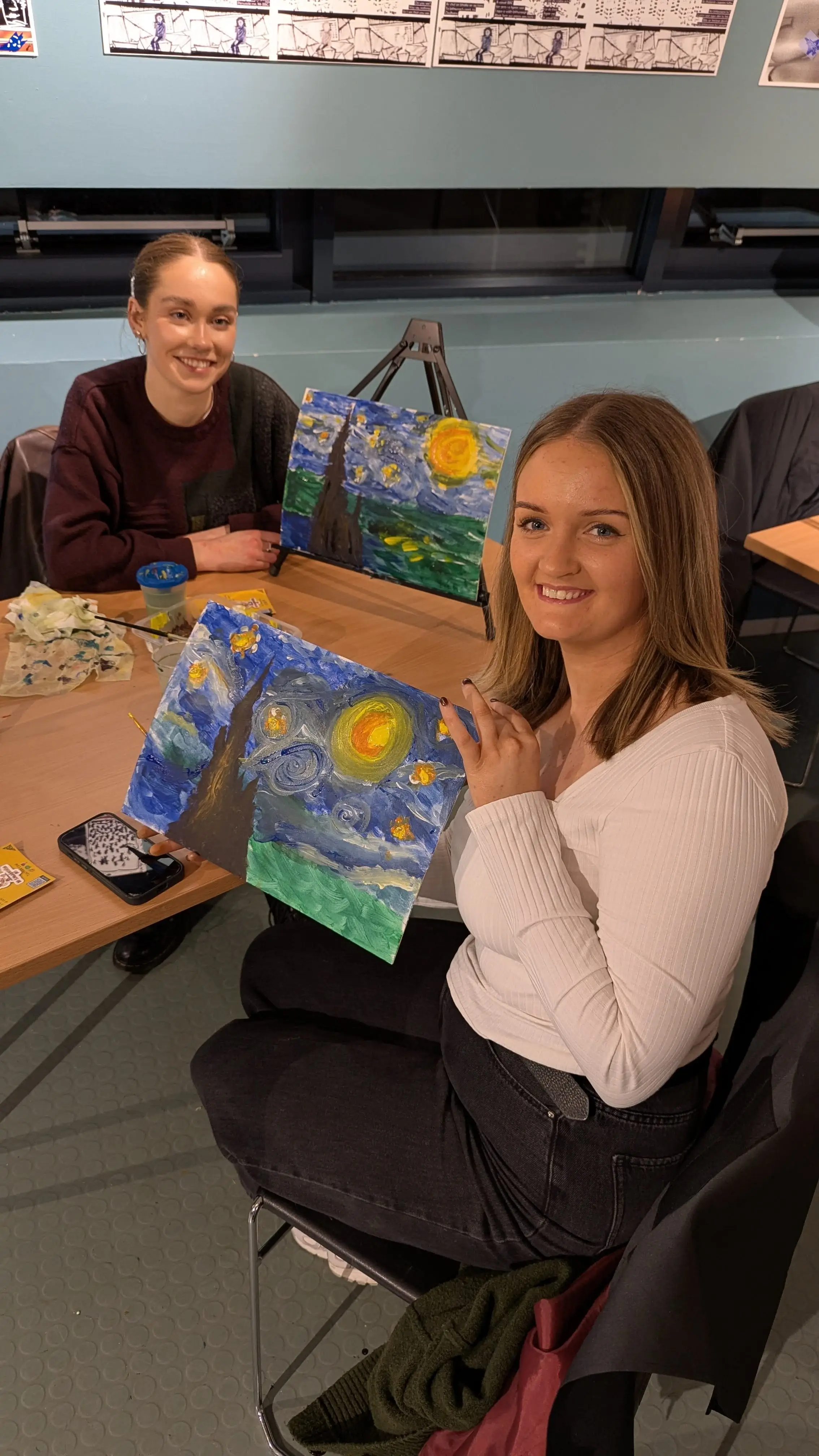 Attendees with their completed paintings